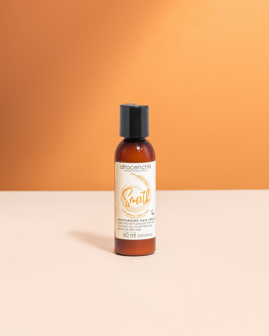 A bottle of Mini Smooth - Natural Moisturising Cream placed against an orange backdrop, with its label facing forward.